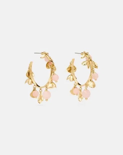 Gold hoop earrings with pink bead charms