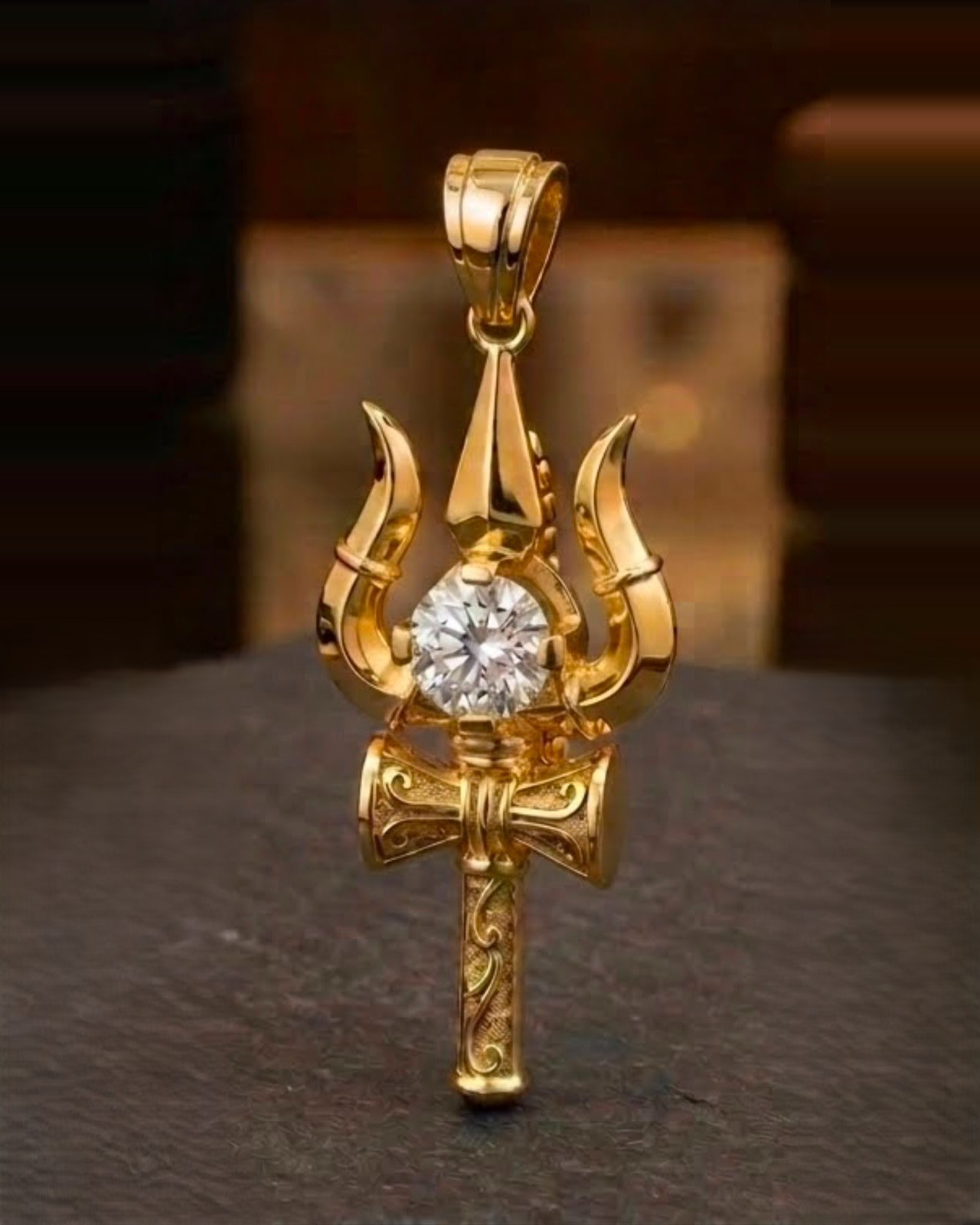 Gold trishul pendant with solitaire stone